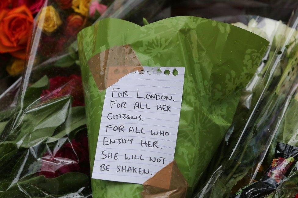 Flowers laid by the public on the ground near London Bridge station