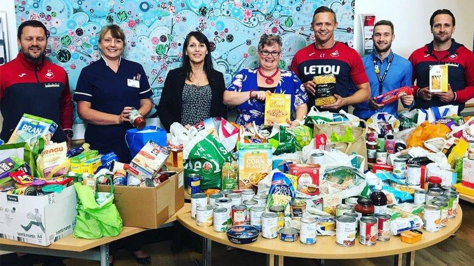 Lee Trundle (third from right) with MP Carolyn Harris (fourth right), Morriston Hospital nurse director Nicola Williams (second left) and members of the Swans Community Trust during the collection from Morriston Hospital