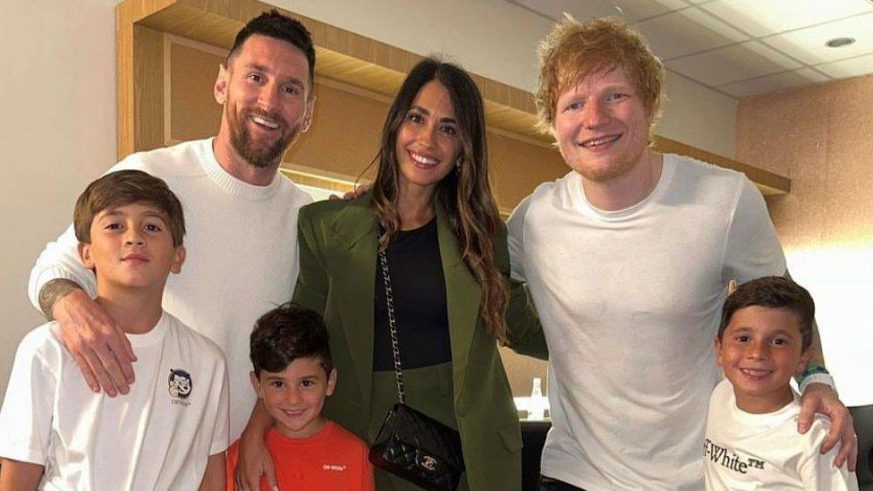 Ed Sheeran, Lionel Messi, his wife and three sons posing for a photo