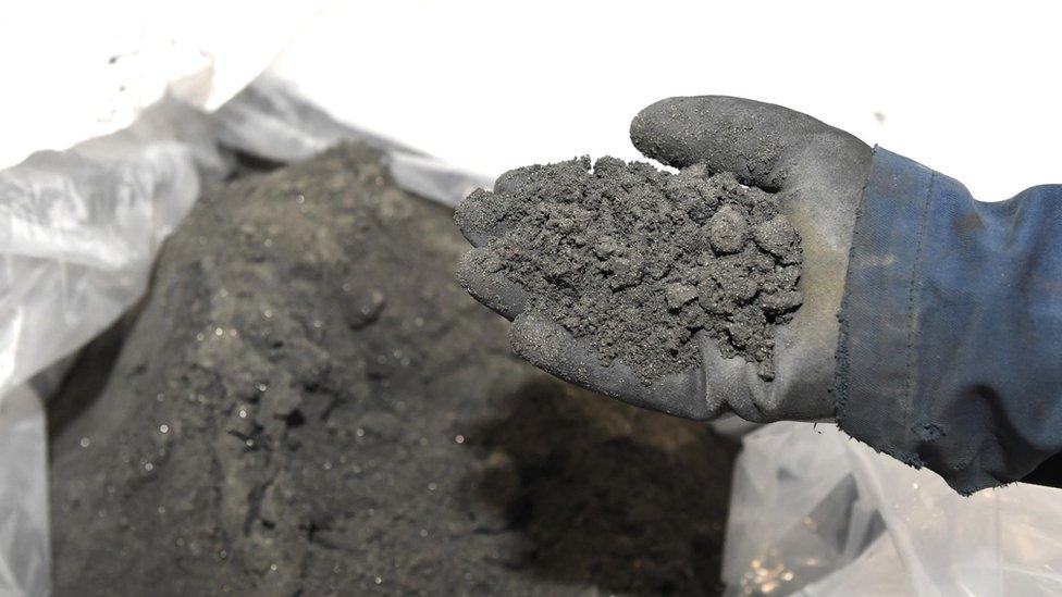 Hand with wet rocks