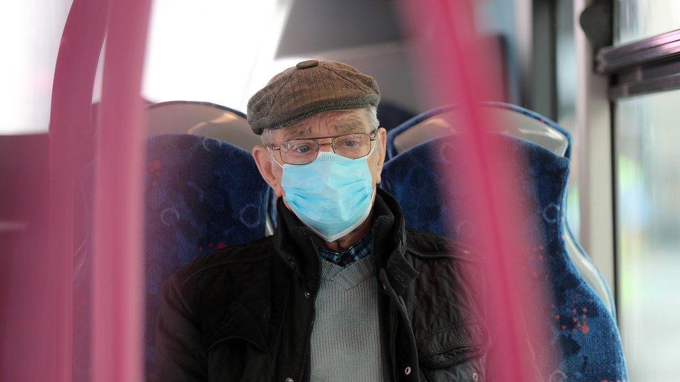 Man wears face mask on bus