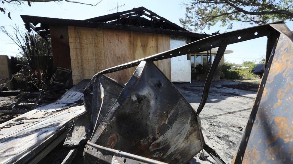 The ruins of a house that burned after a powerful earthquake struck Southern California are seen in the city of Ridgecrest,