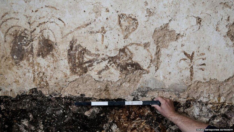 An archaeologist examining one of the inscriptions