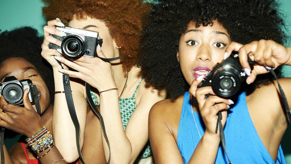 Three women with cameras