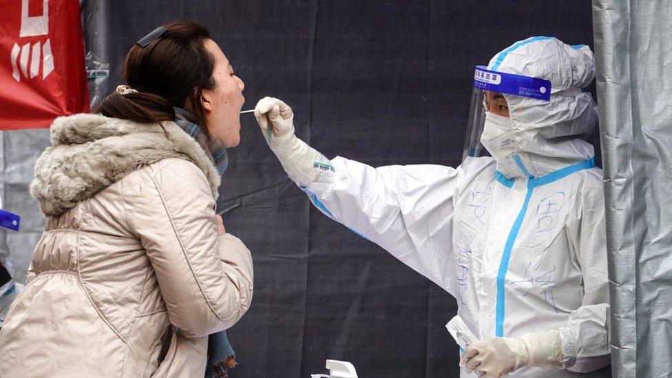 A resident undergoes a nucleic acid test for the Covid-19 coronavirus in Xi'an in China's northern Shaanxi province on December 30, 2021.