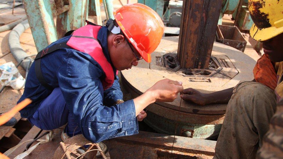 A Chinese technician with China Railway Major Bridge Engineering Company Limited (MBEC), Li Shaoxun, measures the depth of one of the piers on the construction site of a bridge at Kurasini area in Dar es Salaam on March 23, 2013