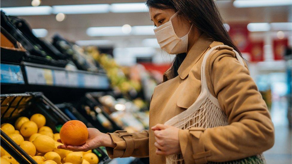 Woman buying oranges