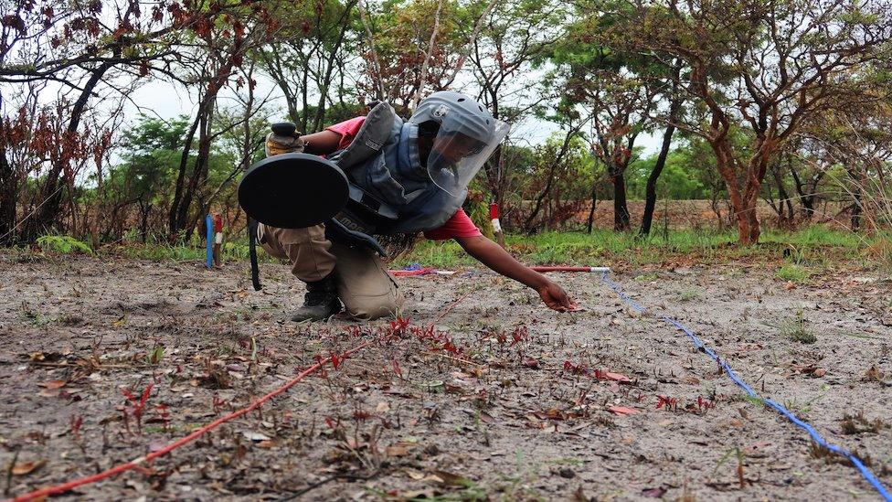 Woman deminer in action