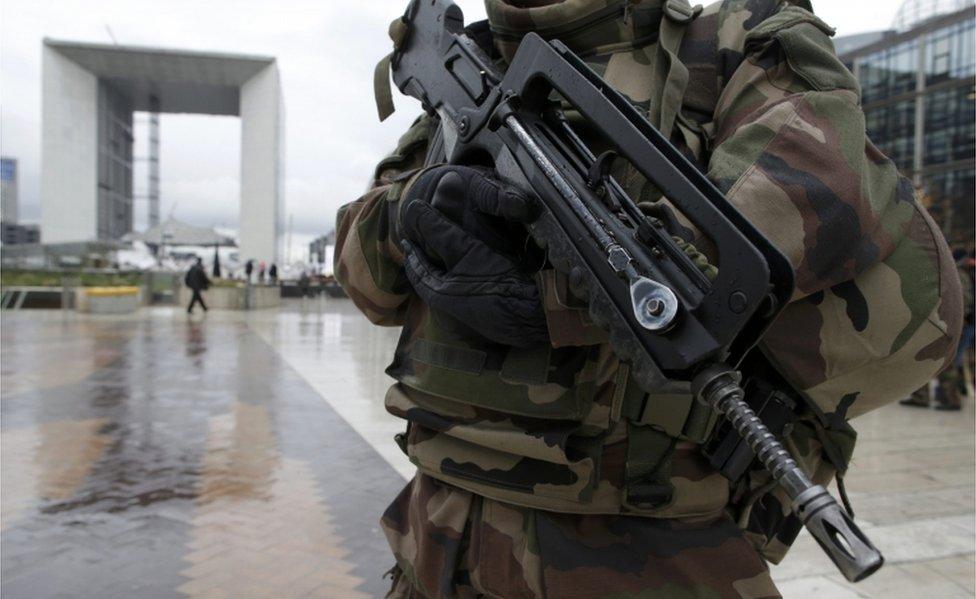 A French soldier patrol near the Arche de la Defense at La Defense business district in Nanterre near Paris, France, 25 November 2015