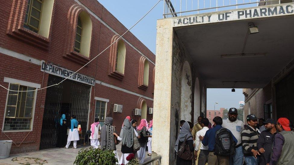 Pakistani students walk outside the pharmacy department at Bahauddin Zakariya University in Multan on December 7, 2015, where female US shooter Tashfeen Malik studied