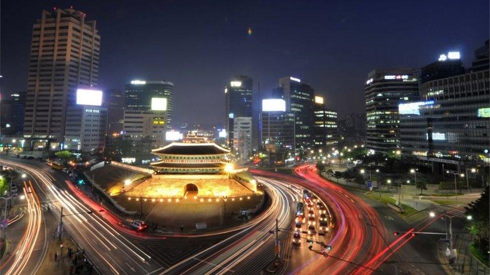 Traffic commuting at night near South Korea"s landmark Namdaemun gate in Seoul