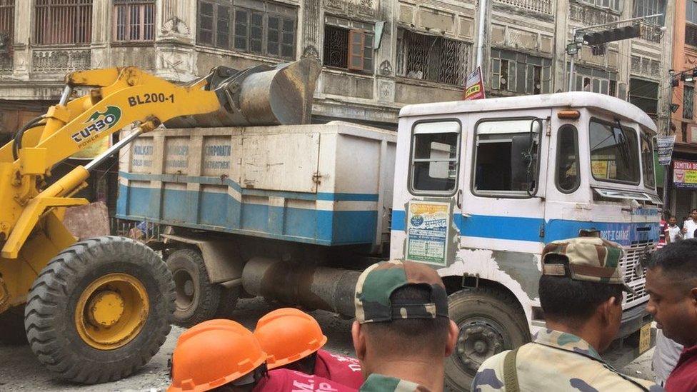 Debris being loaded onto trucks