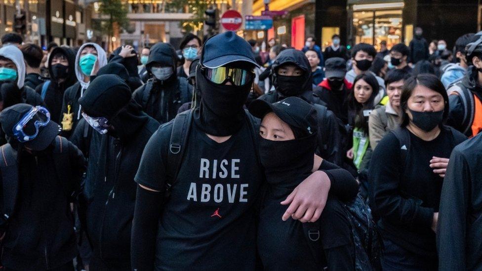 Protesters form a frontline during a stand-off with police at the demonstration