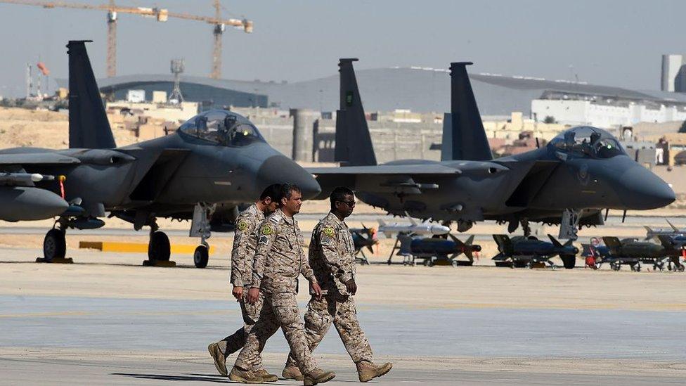 Saudi army officers walk past F-15 fighter jets, GBU bombs and missiles displayed during a ceremony marking the 50th anniversary of the creation of the King Faisal Air Academy at King Salman airbase in Riyadh on January 25, 2017