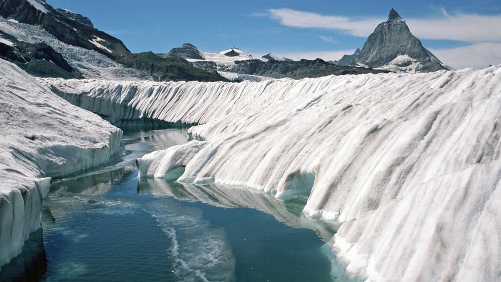 Meltwater pond on the Gorner Glacier, Switzerland. The Matterhorn can be seen in the background.