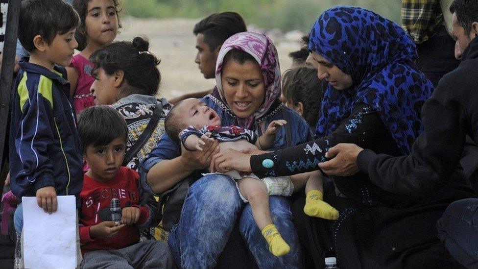 Refugees wait to cross the border of Greece with Macedonia