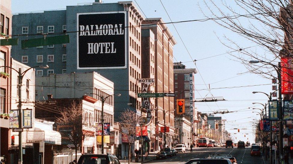 Traffic moves along a street February 25, 2002 in downtown eastside Vancouver, Canada