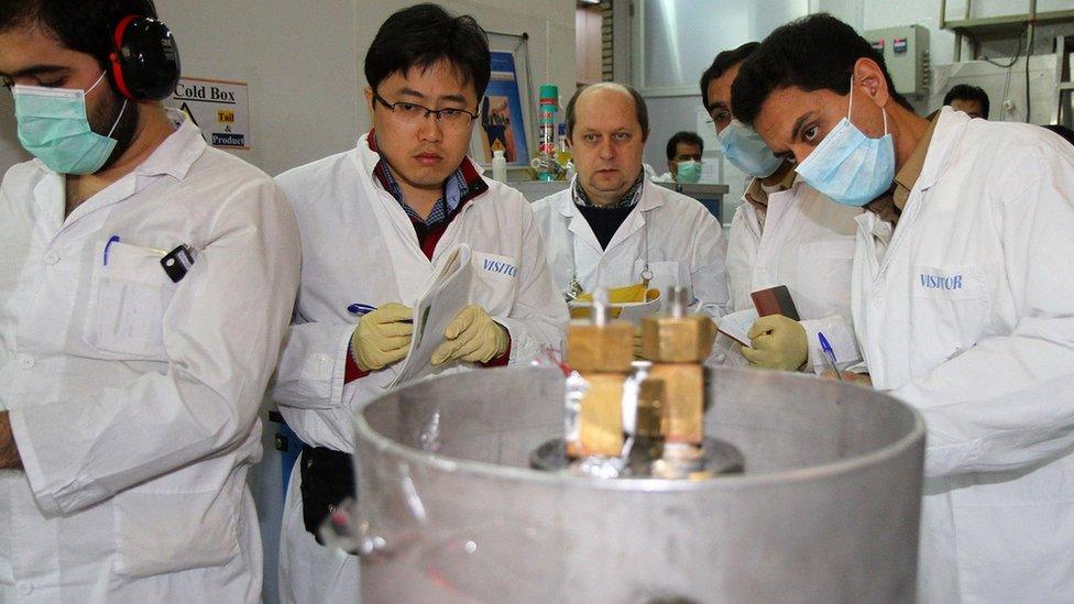 International Atomic Energy Agency (IAEA) inspectors and Iranian technicians disconnect the connections between the twin cascades for 20%-enriched uranium production at Natanz, Iran, 20 January 2014