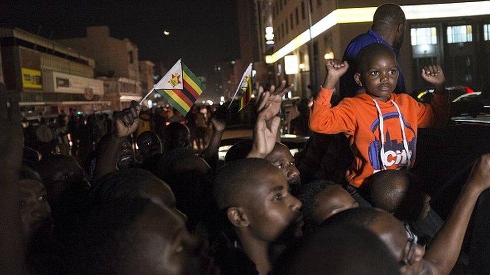 HARARE, ZIMBABWE - NOVEMBER 21: Zimbabweans shout slogans and wave flags as they celebrate after the resignation of President Robert Mugabe who has ruled the country for 37 years, in Zimbabwe's capital Harare on November 21, 2017.