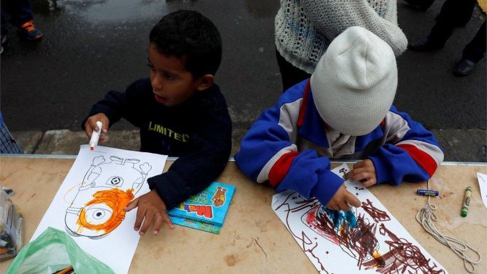 Children draw at a stadium in Mexico City