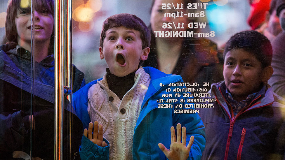 Boy at shop window on Black Friday