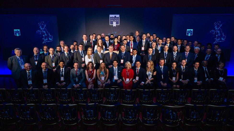 Prince Andrew with a group of people in front of a Pitch@Palace logo