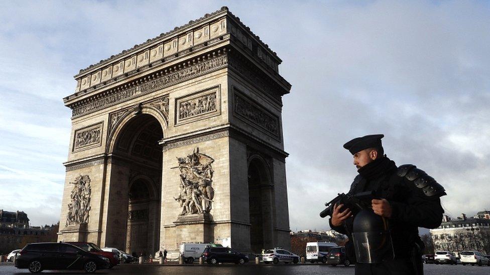 A French riot police officer stands guard in front of the Arc de Triomphe after violent protests in Paris, France, on 2 December 2018