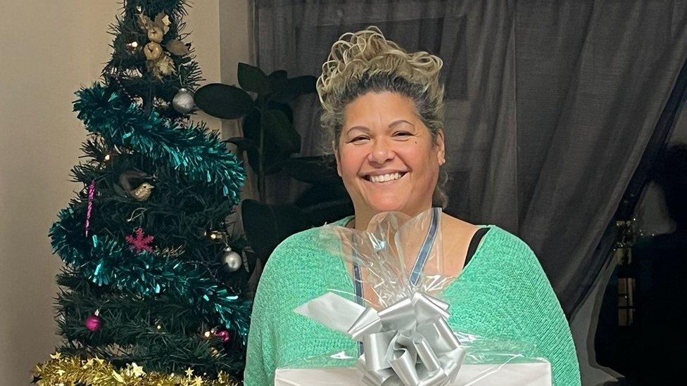 woman smiling by xmas tree
