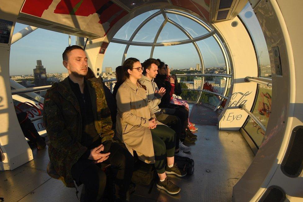 Londoners on the London Eye during the solstice sunrise