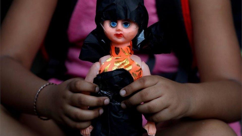 A child attends a protest against the rape of an eight-year-old girl, in Kathua, near Jammu and a teenager in Unnao, Uttar Pradesh state, in New Delhi, India April 15, 2018.