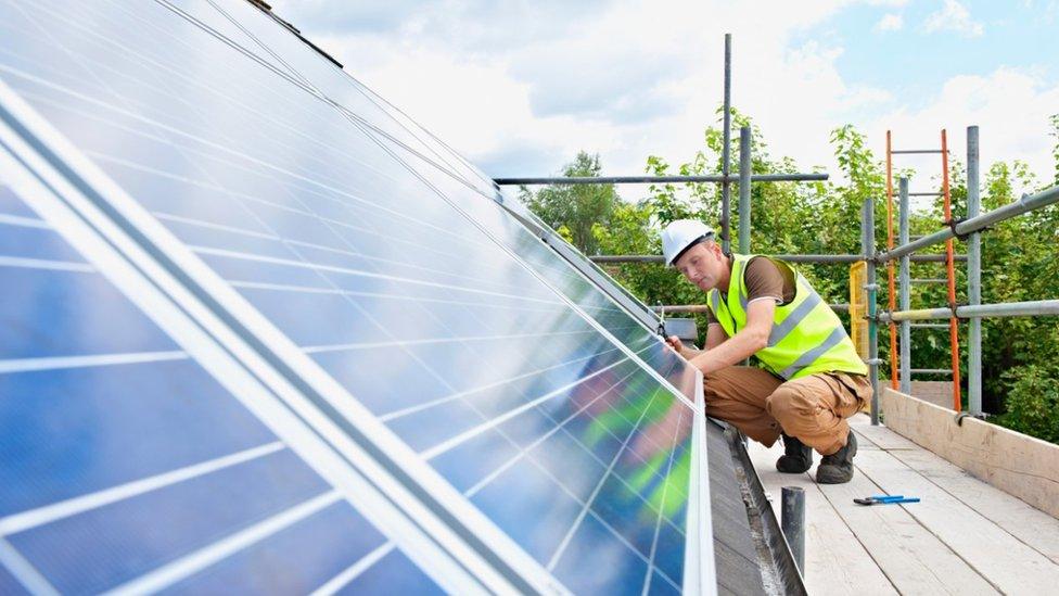 Man fitting solar panel