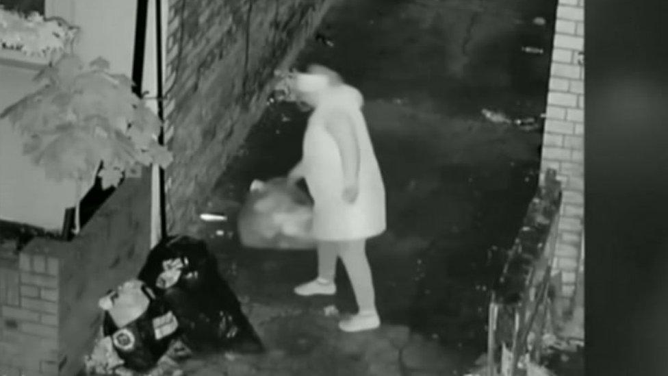 Woman dumping bag of rubbish