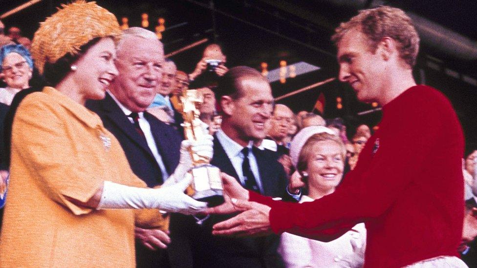 Queen Elizabeth II presents the World Cup, the Jules Rimet trophy, to England"s team captain Bobby Moore on 30 July, 1966