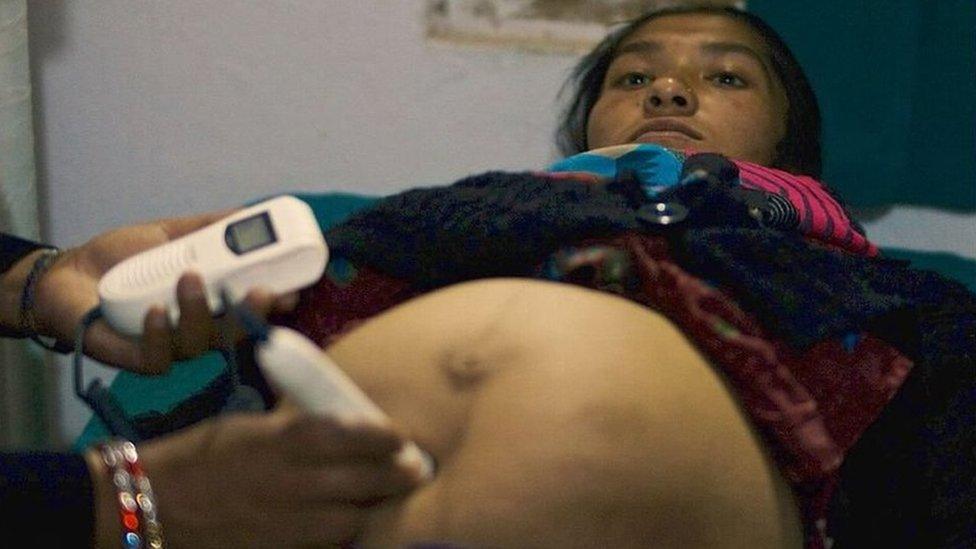 Heavily pregnant Hari Sunar has her baby's heart rate monitored by a midwife