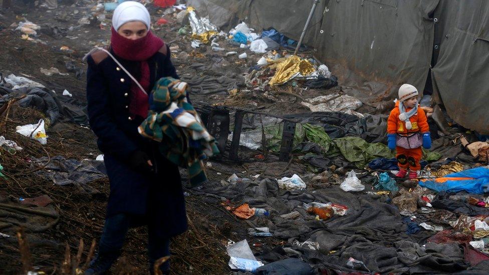 Migrants wait to enter into Croatia from Serbia, near the village of Berkasovo, Serbia, Thursday, Oct. 22, 2015