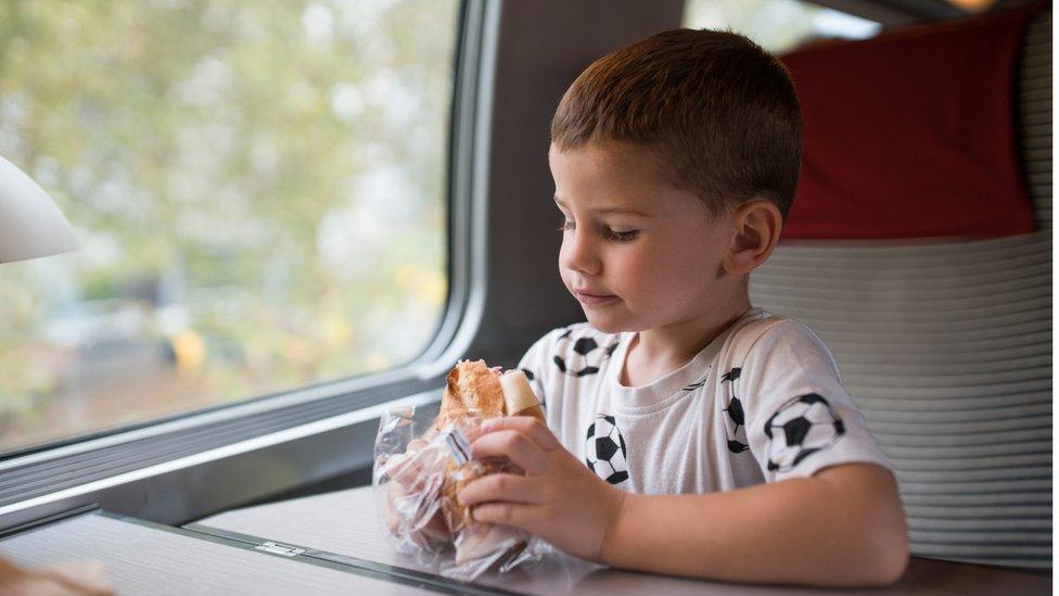 boy-eating-on-train.