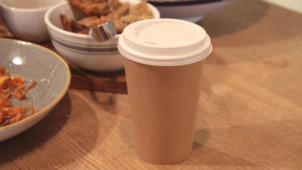 Compostable coffee cup on table