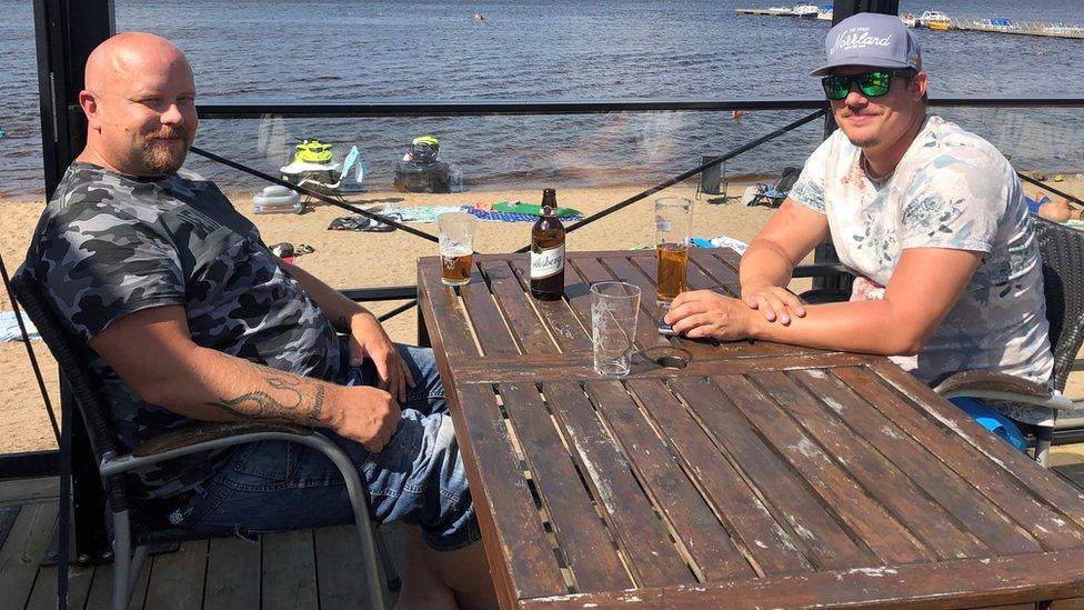 Swedes enjoy a drink by a lake north of Stockholm. File photo