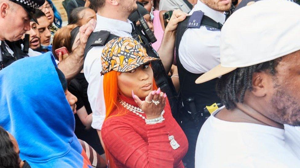 Nicki Minaj surrounded by police and fans