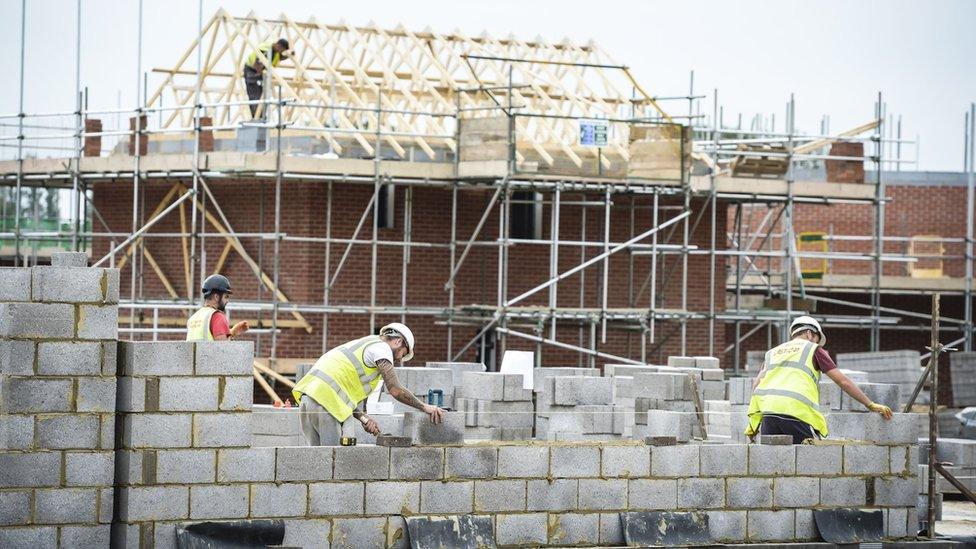 Builders working on a house