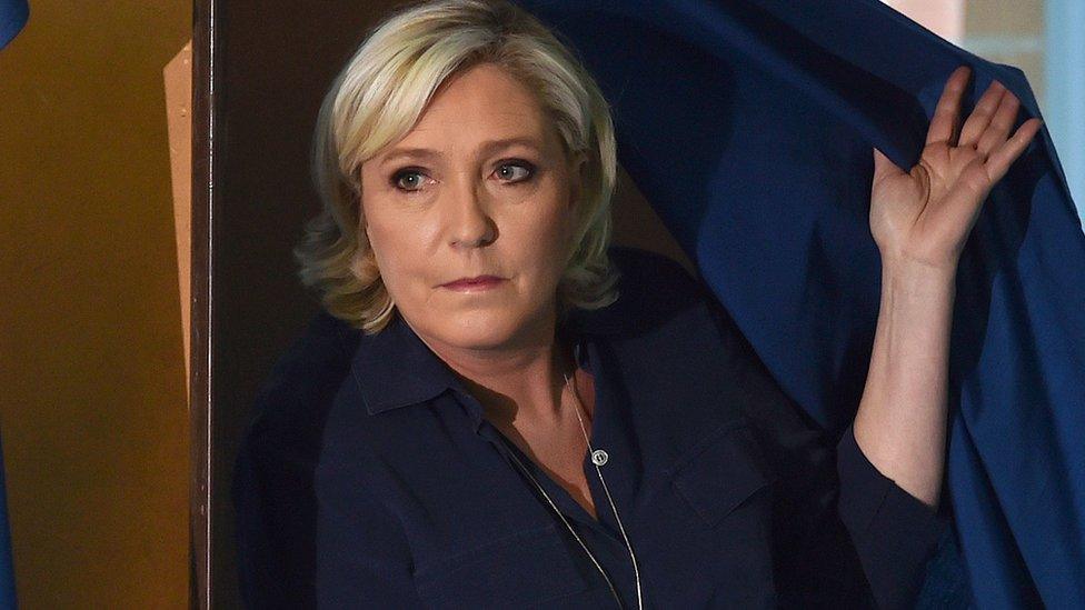 National Front (FN) leader Marine Le Pen walks out of a voting booth in Henin-Beaumont in northern France on June 11, 2017