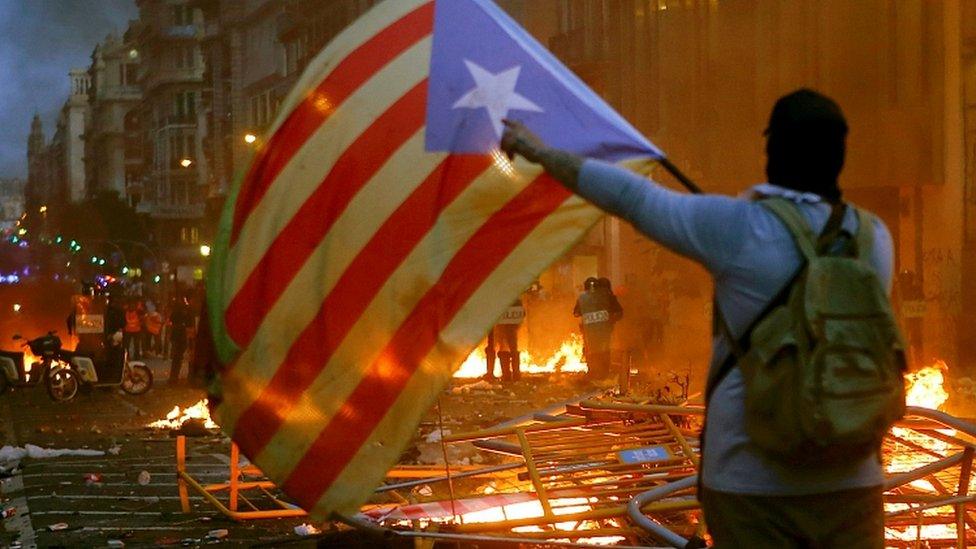 People wave "Esteladas" flag as thousands take part in "Marches for Freedom" along Pelayo street in Barcelona, Spain, 18 October 2019