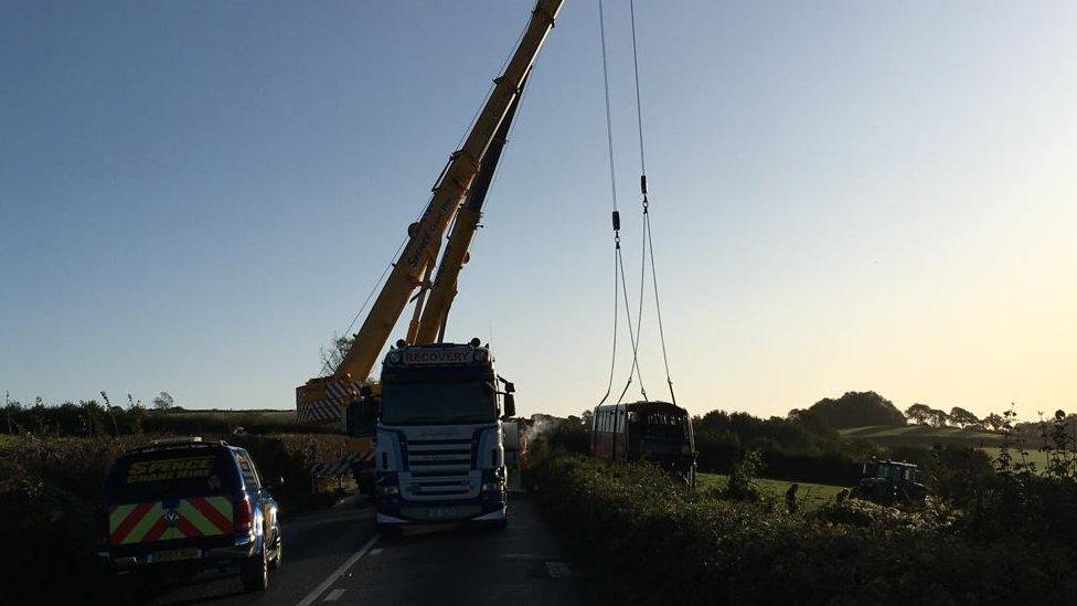 Crane lifting bus