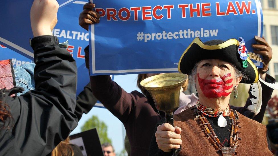 Tea Party member Susan Clark of Santa Monica, California, rings a bell as Obamacare supporters shout slogans in front of the U.S. Supreme Court March 28, 2012