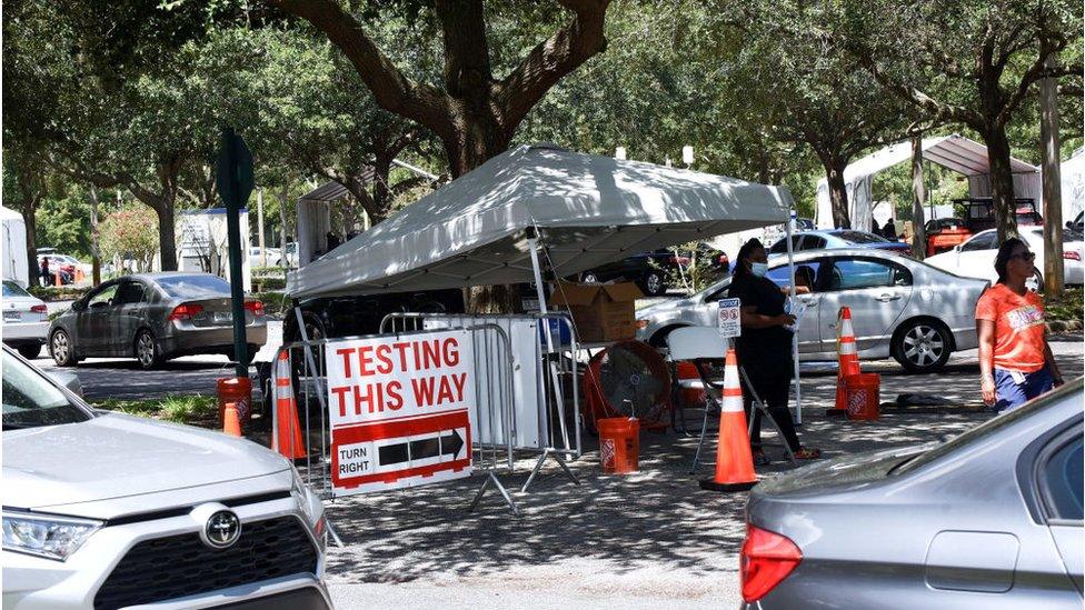 People in cars wait at a COVID-19 testing and vaccination site at Barnett Park.