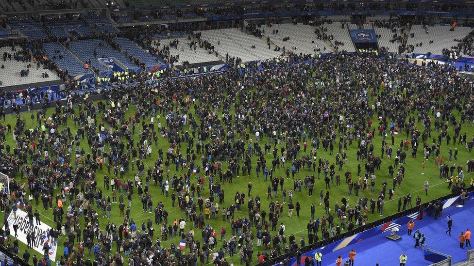 Spectators crowded onto the pitch