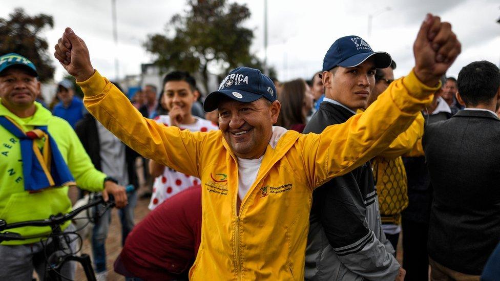 Colombian cycling coach Fabio Rodriguez - coach of Colombian cyclist Egan Bernal - celebrates as he watches the Tour de France in Zipaquira