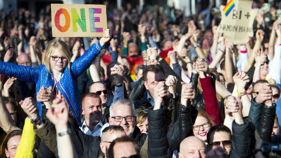 People hold hands during the Hand in Hand for Diversity, a demonstration against anti-LGBT violence triggered after a gay couple was beaten up, on April 8, 2017 in Arnhem