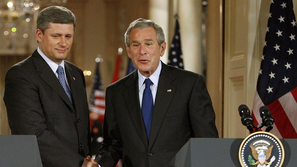 Canadian Prime Minister Stephen Harper shakes George W Bush's hand.