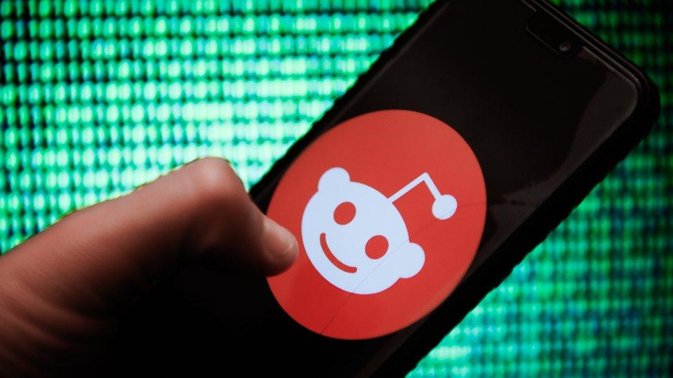 A Reddit logo on a smartphone